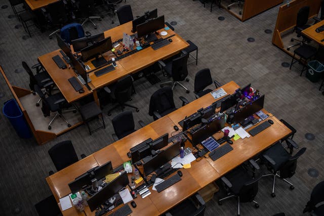 <p>Empty desks are seen inside the Lloyds of London building on 20 December, 2021 in London, England</p>
