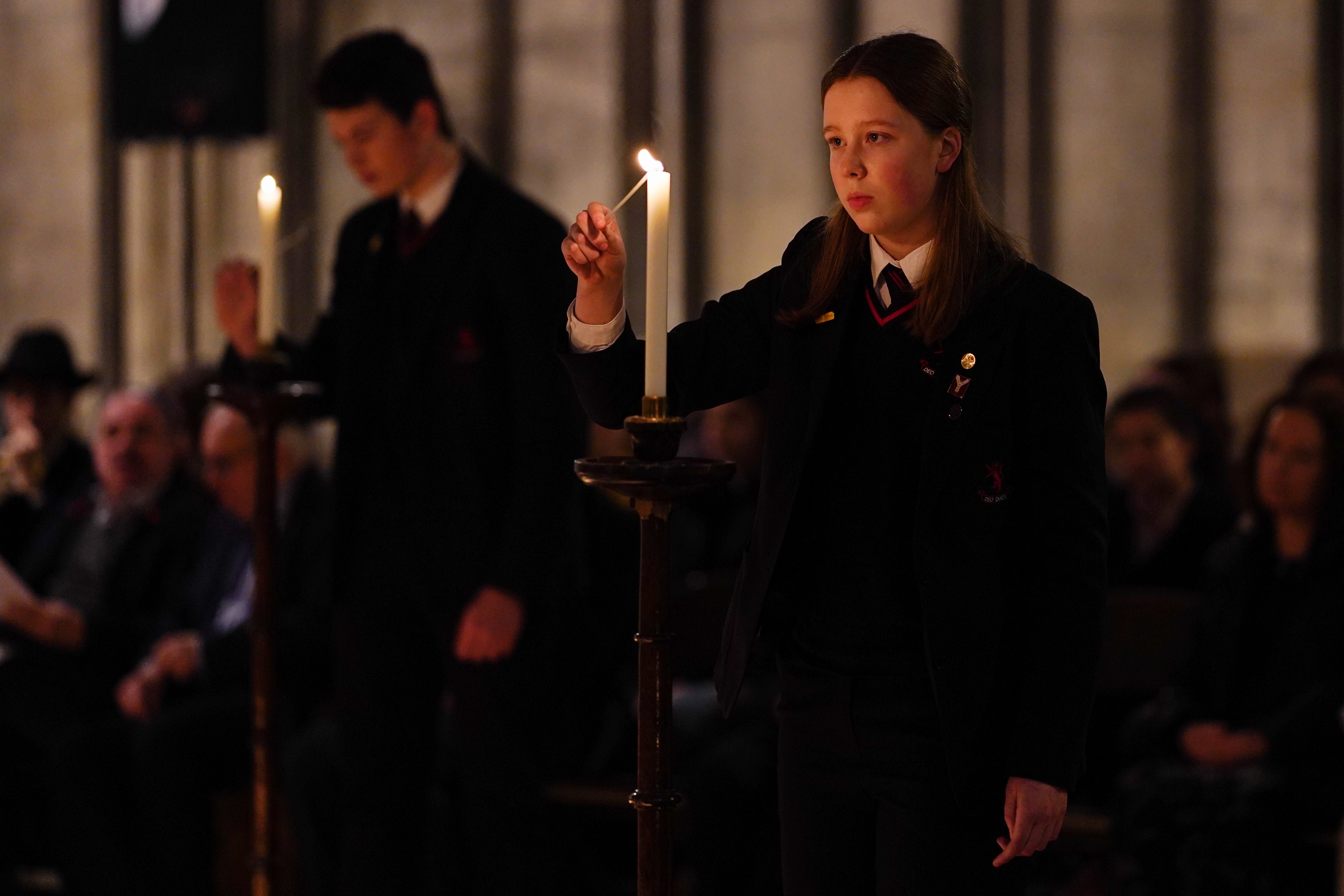 School children light candles as 600 candles are lit in a Star of David set out on the floor of the Chapter House of York Minster as part of a commemoration for Holocaust Memorial Day on 23 January 2020 in York. (Photo by Ian Forsyth/Getty Images)