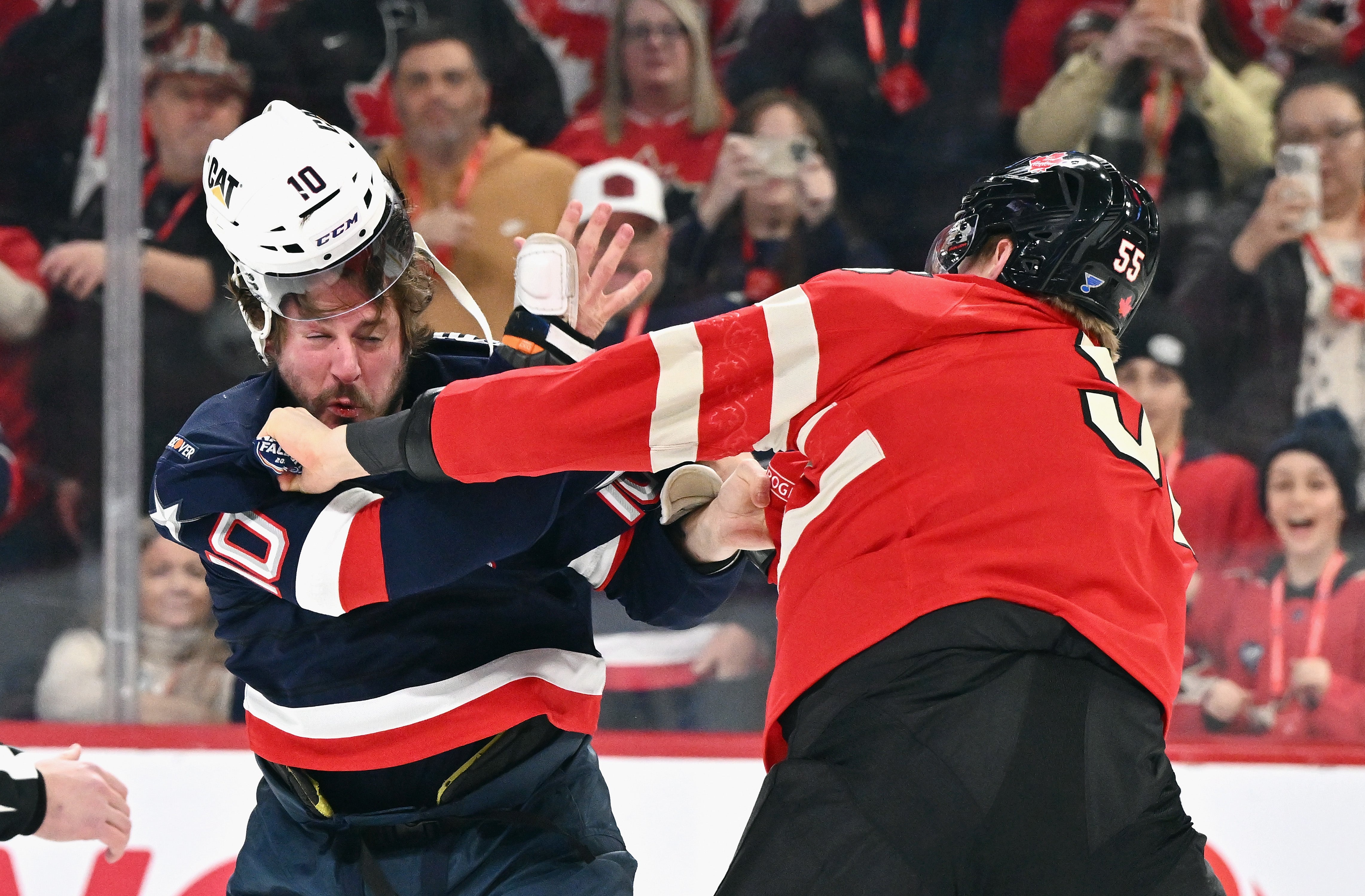 J.T. Miller #10 of Team USA and Colton Parayko #55 of Team Canada fight during the first period in the 4 Nations Face-Off game at the Bell Centre