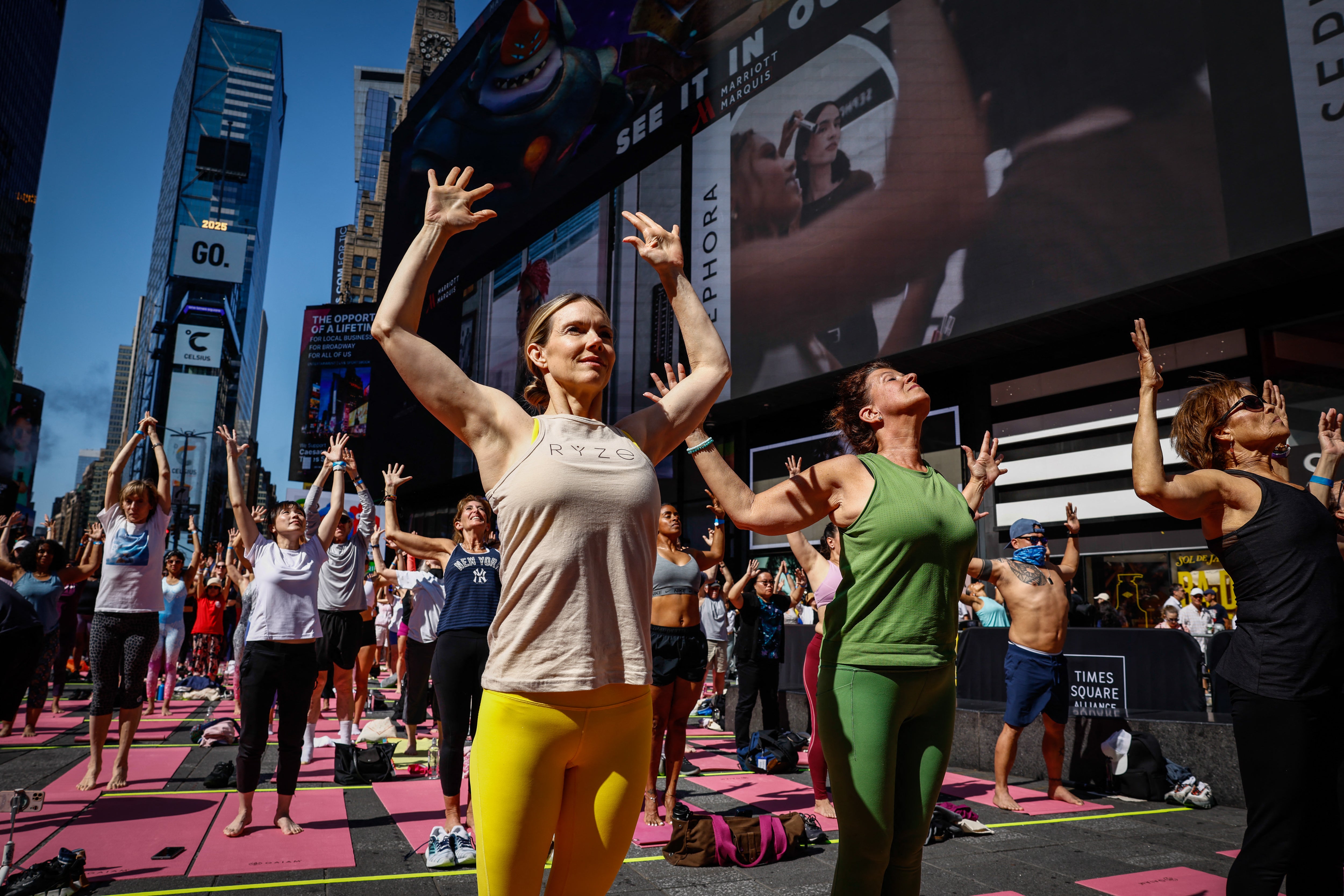 People taking part in a yoga session in New York City in June 2025. Yoga can help improve mobility, with benefits as we age