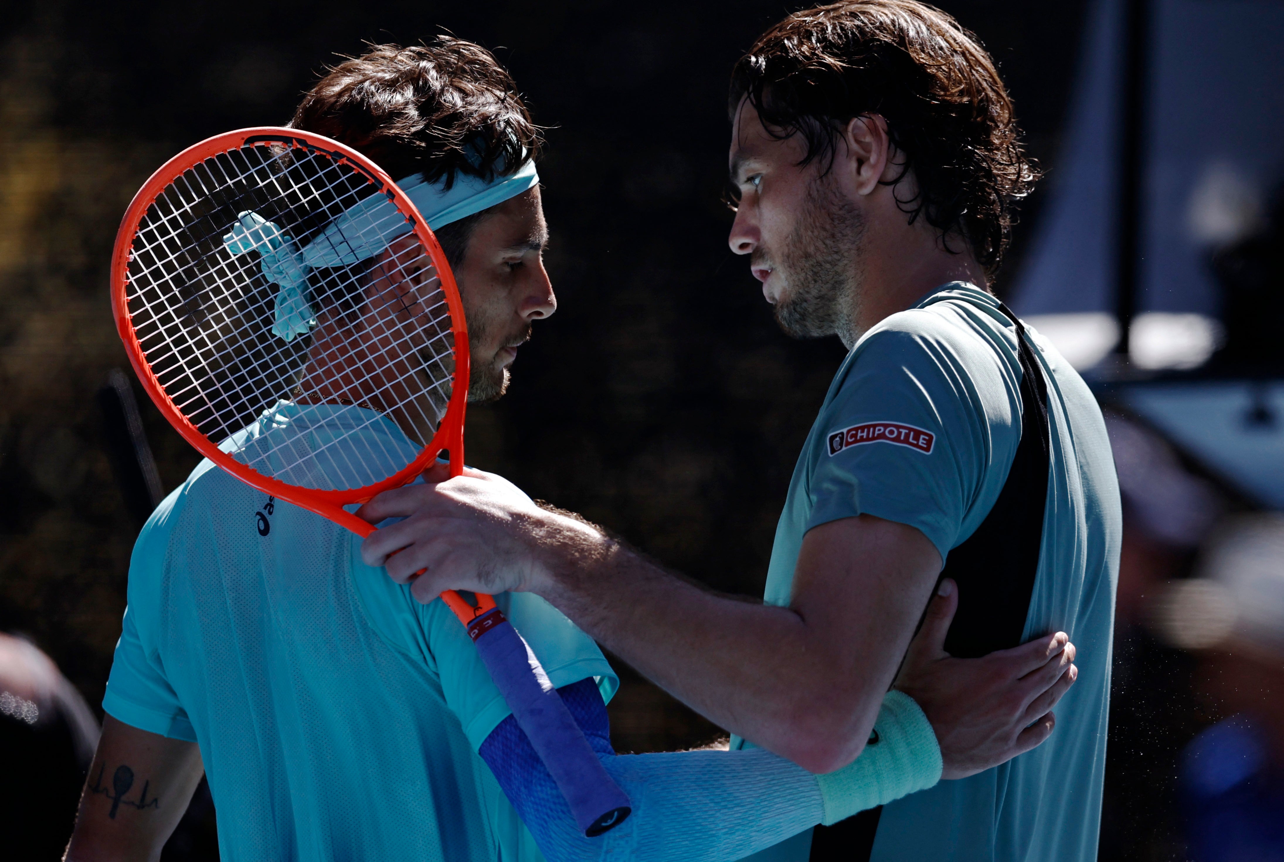 <p>Italy's Lorenzo Musetti shakes hands with Taylor Fritz as he set up a quarter-final with Novak Djokovic</p>