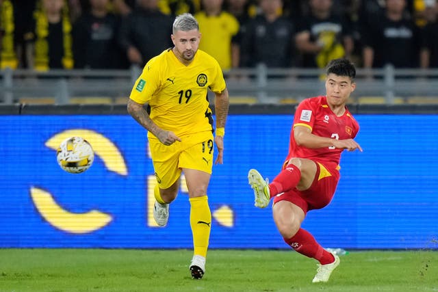 <p>Malaysia's Rodrigo Holgado, left, vies for the ball with Vietnam's Do Duy Manh during the AFC Asian Cup qualifier Group F</p>