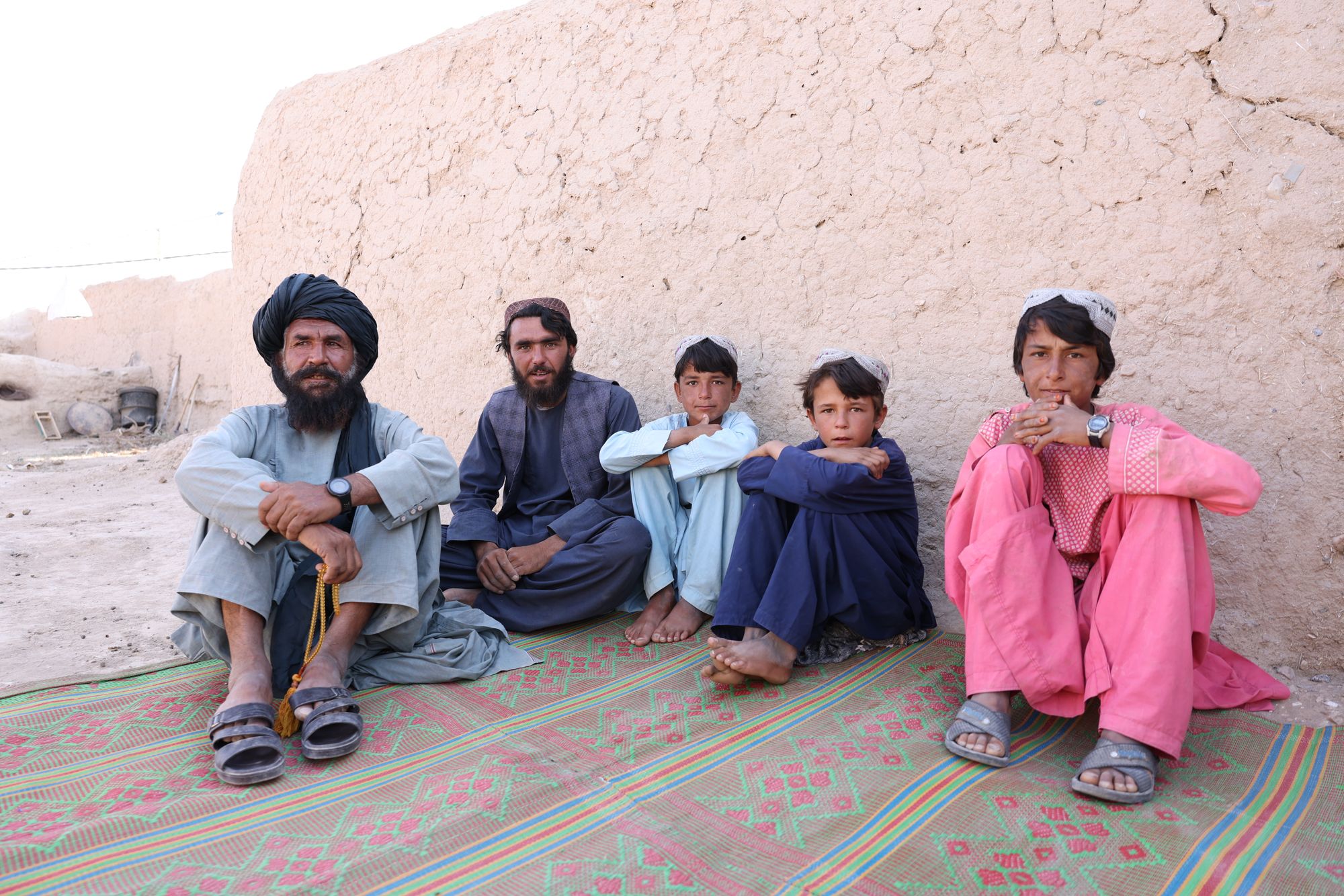 Wasiq, a 60-year-old farmer (L) pictured here sitting members of his family, describes the drought as a ‘silent killer’