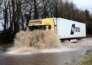 A truck makes its way along a flooded road as Storm Chandra triggered amber wind and rain warnings for much of the United Kingdom, in Antrim, Northern Ireland