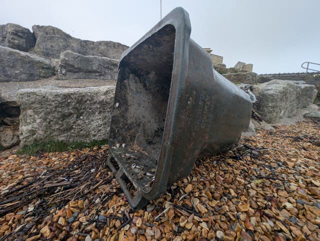 <p>A wheelie bin that has washed up on the south coast of England </p>