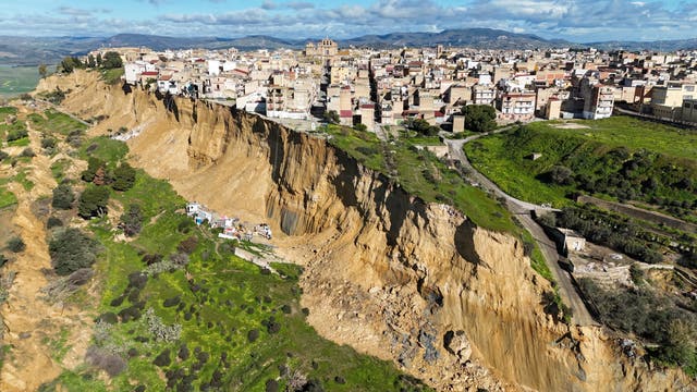 <p>A drone picture shows houses perched along the edge of a cliff after a landslide in Niscemi, Sicily, Italy</p>
