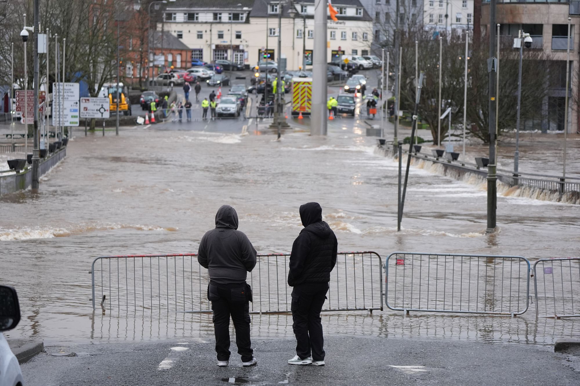<p>People look at floodwater in Enniscorthy, Co. Wexford</p>