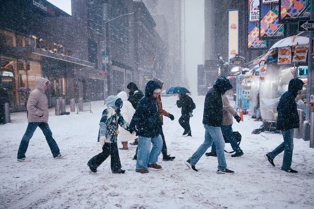 <p>People cross the street after a snowstorm in New York City this past weekend. The U.S. finally has some good news this flu season</p>
