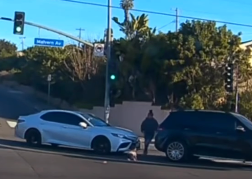 A woman has been arrested in California after heart-stopping footage showed the moment a 19-month-old baby flew out of the passenger door of a moving vehicle and into the path of oncoming traffic