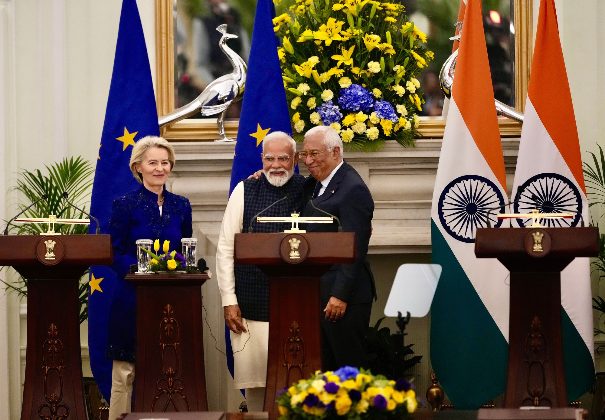 European Commission president Ursula von der Leyen, left, looks on as Indian prme minister Narendra Modi, centre, and European Council president Antonio Costa greet each other after reaching a free trade agreement in Delhi