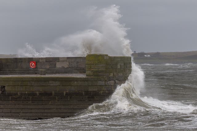<p>Waves crash against the sea wall near the lighthouse at Donaghadee Harbour </p>