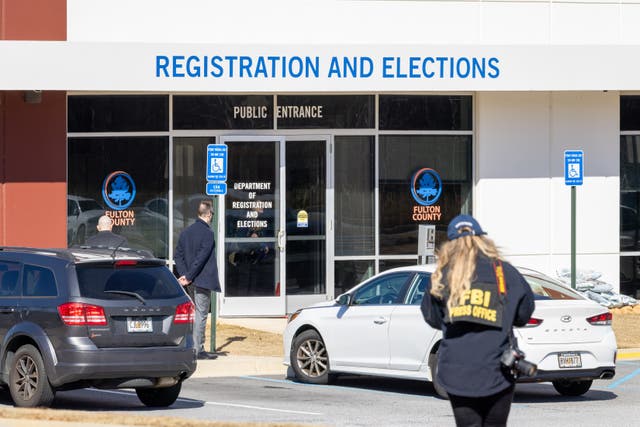 <p>FBI agents are seen executing a search warrant at the Fulton County elections office near Atlanta</p>