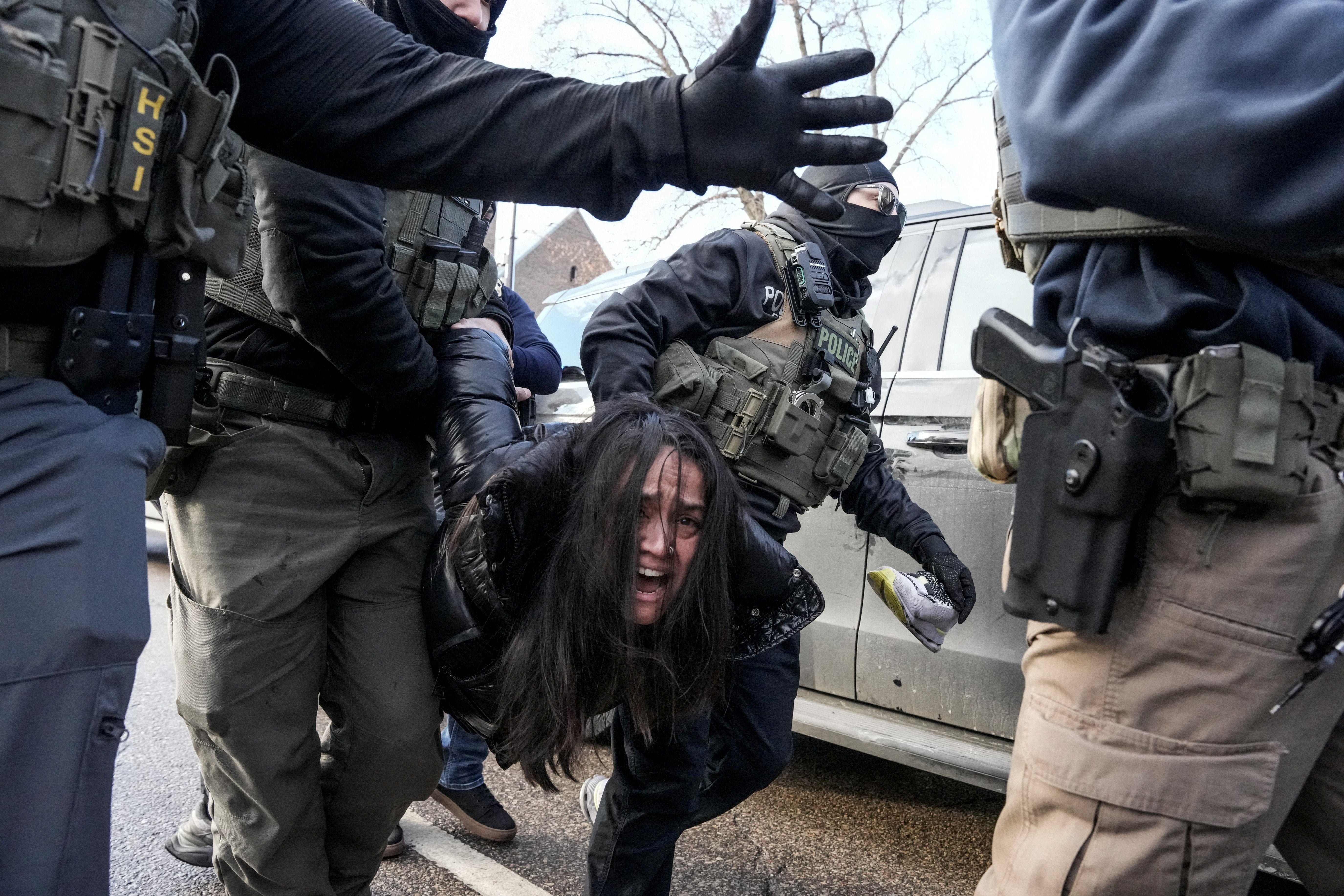 Federal agents carry Rahman away, on Jan. 13, 2026, just days after an ICE agent fatally shot Renee Nicole Good, in Minneapolis, Minnesota.