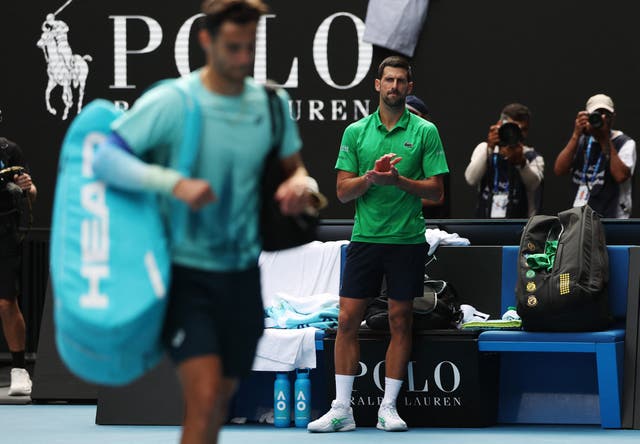 <p>Novak Djokovic applauds the injured Lorenzo Musetti from the court</p>