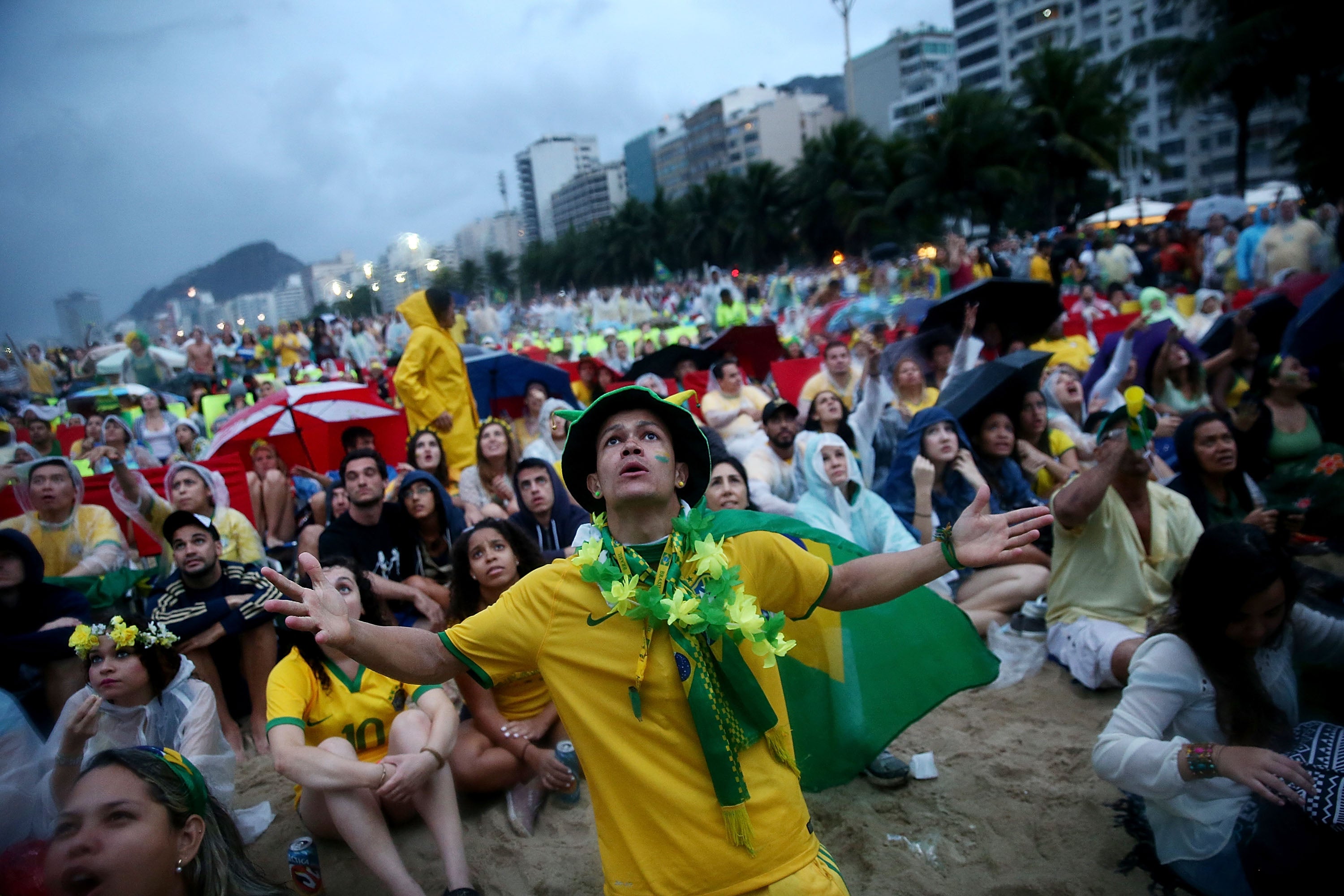 Brazil fans watch the first half on Copacabana Beach during the 2014 Fifa World Cup semi-final match between Brazil and Germany on 8 July 2014 in Rio de Janeiro, Brazil.