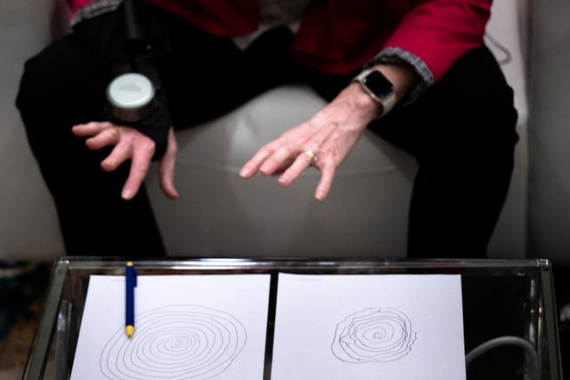 <p>Roberta Wilson-Garrett, of Blind River, Ontario, who has Parkinson's disease, shows the difference in drawing spirals made with and without her GyroGlove, made by GyroGear, which uses a gyroscope to help stabilize tremors at the Mandalay Bay resort before this weeks Consumer Electronics Show (CES) on January 8, 2024 in Las Vegas, Nevada. </p>