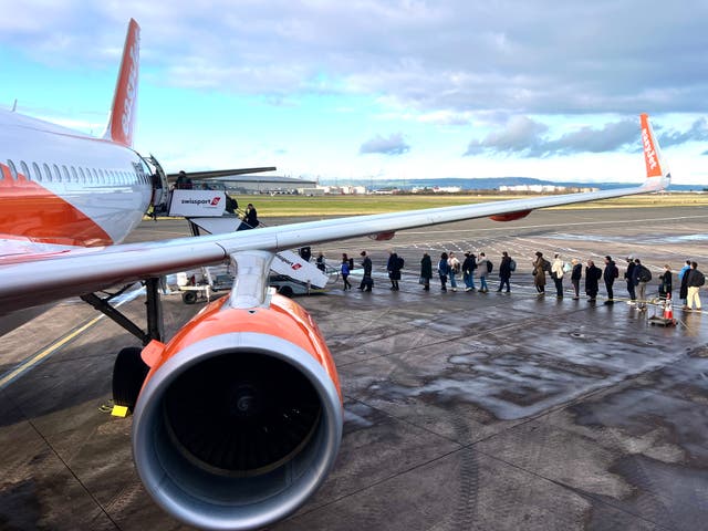 <p>Blue sky thinking: Passengers boarding an easyJet flight at Belfast City airport</p>