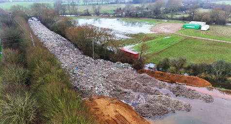 <p>The 150m long mountain of rubbish that has been illegally dumped beside the A34 and near the River Cherwell in Kidlington, Oxfordshire </p>