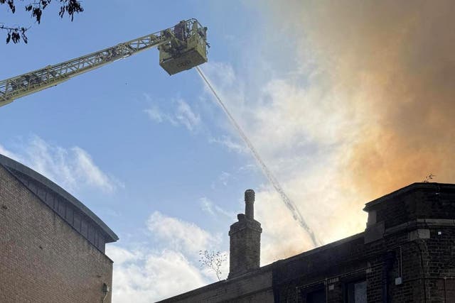 <p>Firefighters are tackling a blaze near the railway line in Camden</p>