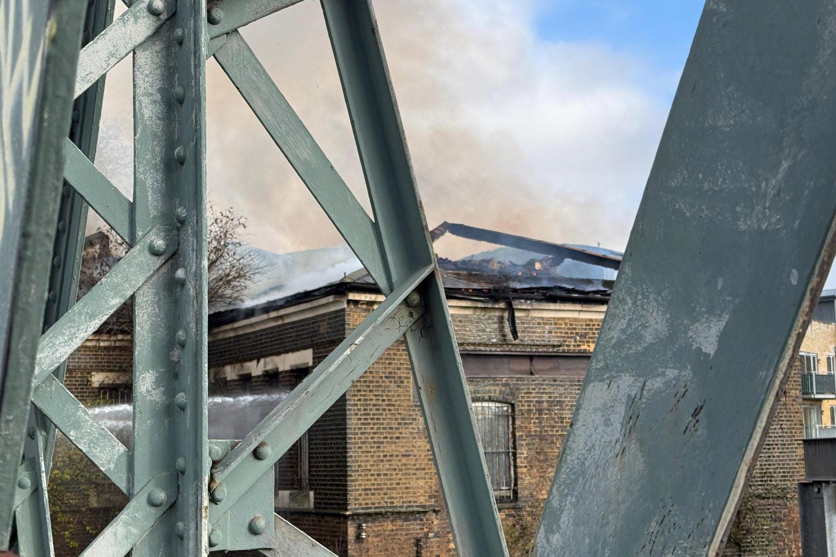 Fire crews tackle a fire near the railway line in Camden