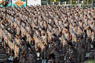 Members of Iran's Islamic Revolutionary Guard Corps (IRGC) giving a military salute during a military parade in Tehran