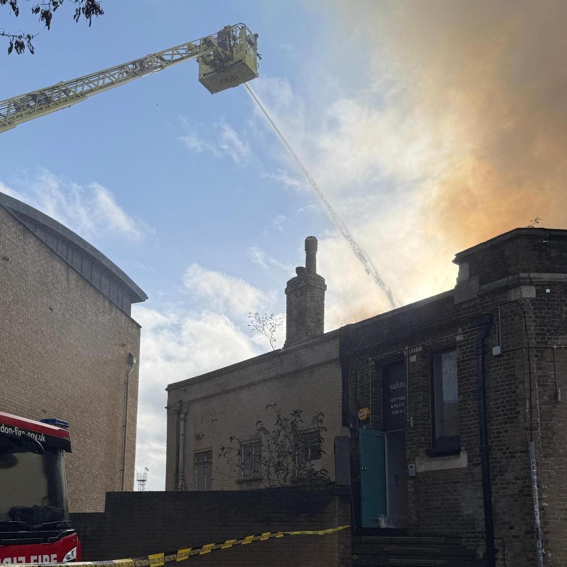 Firefighters are tackling a blaze near the railway line in Camden