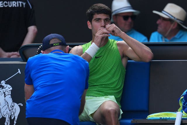 <p>Carlos Alcaraz of Spain receives treatment during his semi-final match against Alexander Zverev</p>