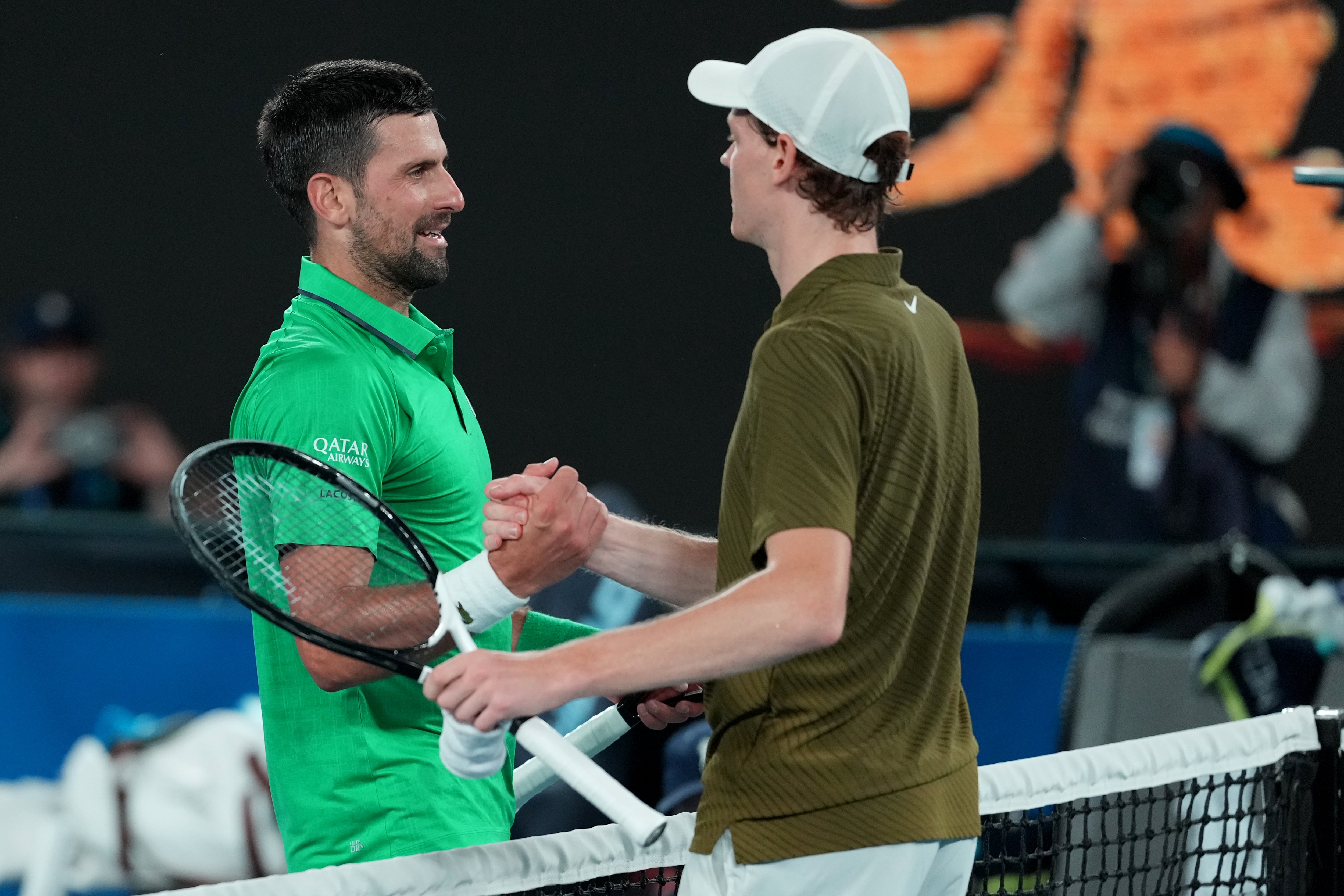 Djokovic sharing a moment of respect with Jannik Sinner after beating the defending champ