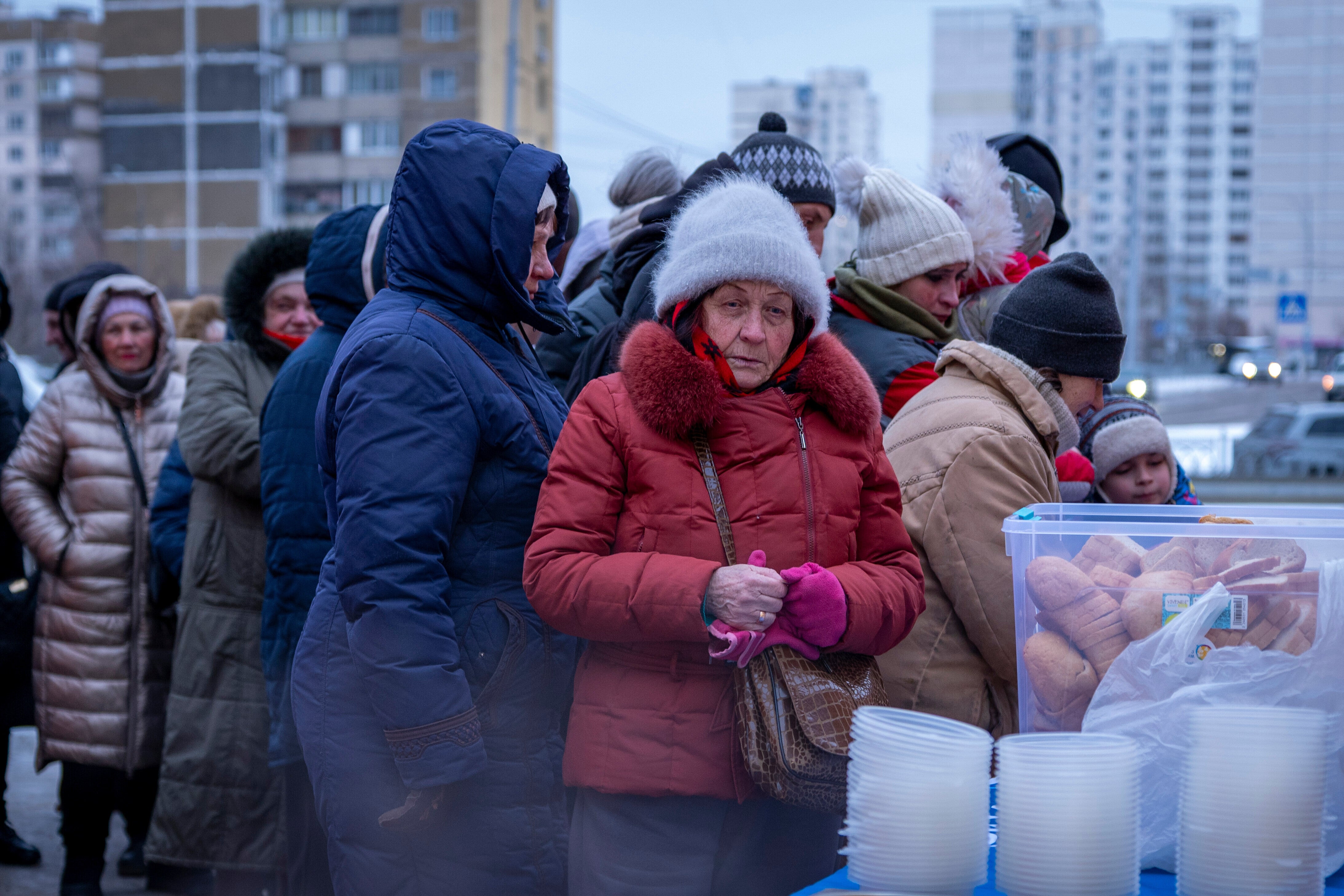 People who have no power at home following Russia's air attacks wait in line to receive free hot meals in a residential neighbourhood in Kyiv, Ukraine, Friday, Jan. 30, 2026