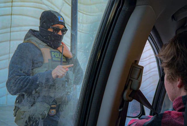 <p>An ICE agent threatens a volunteer with arrest if they keep following his car amid a violent crackdown in Minneapolis </p>