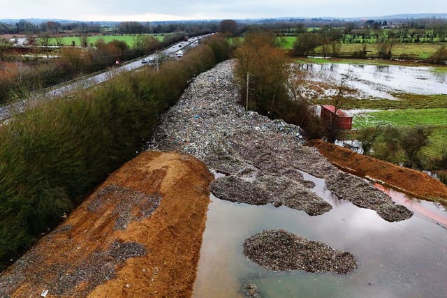 <p>The 150m long mountain of rubbish that has been illegally dumped beside the A34 and near the River Cherwell in Kidlington</p>