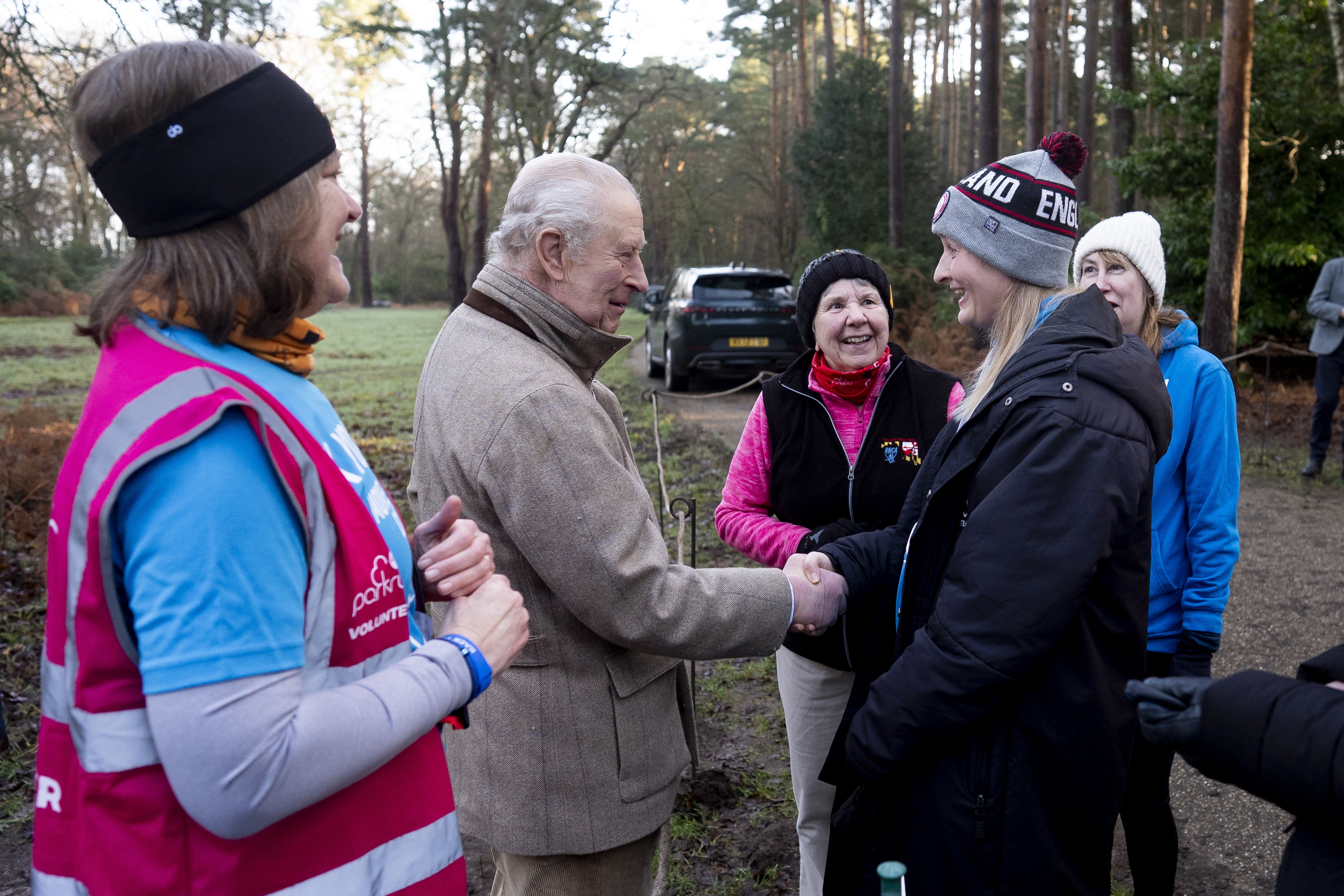 Charles and volunteer Sarah Byatt (left) speak to members of the Sandringham parkrun