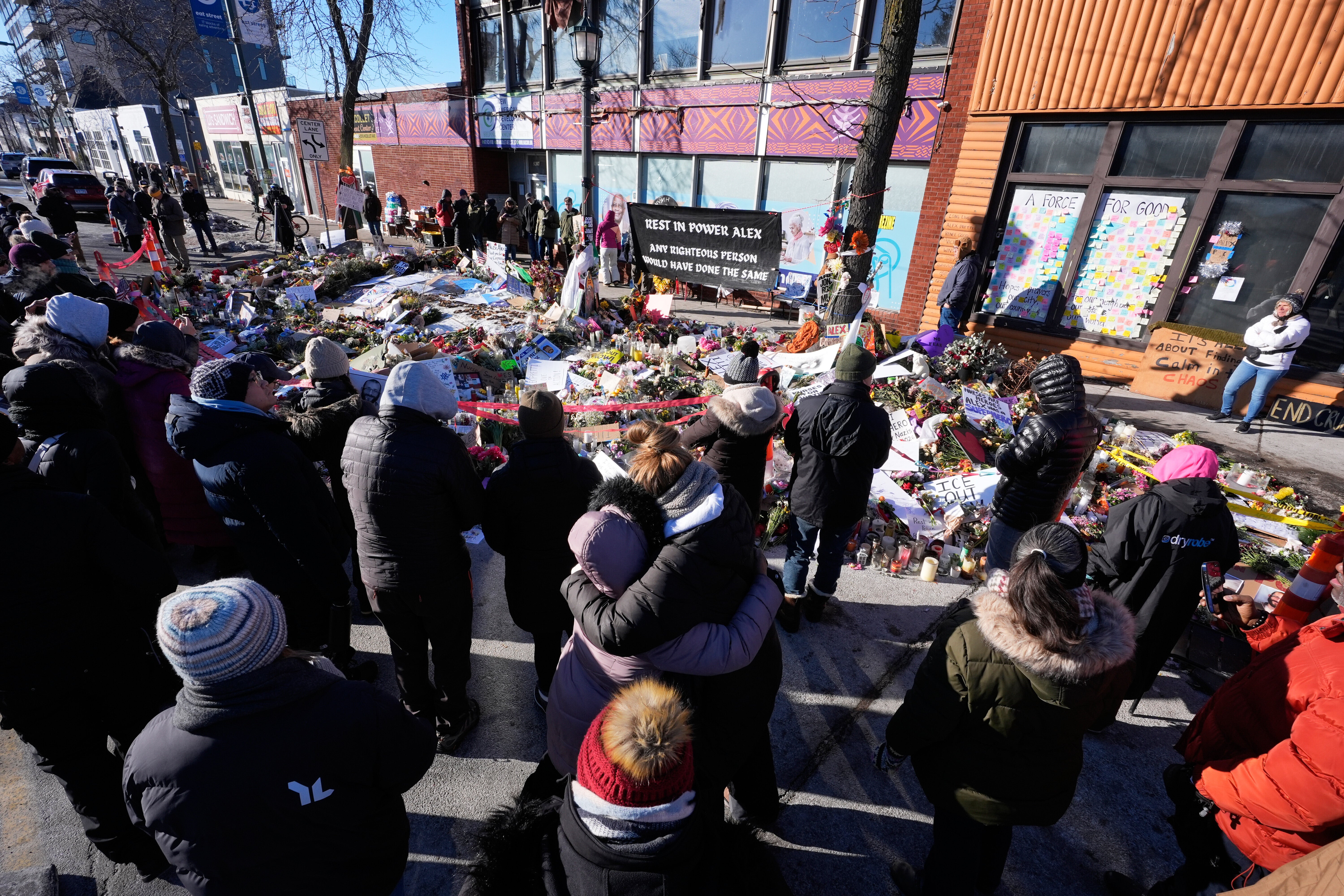 People gather around a memorial site for Alex Pretti on Saturday in Minneapolis