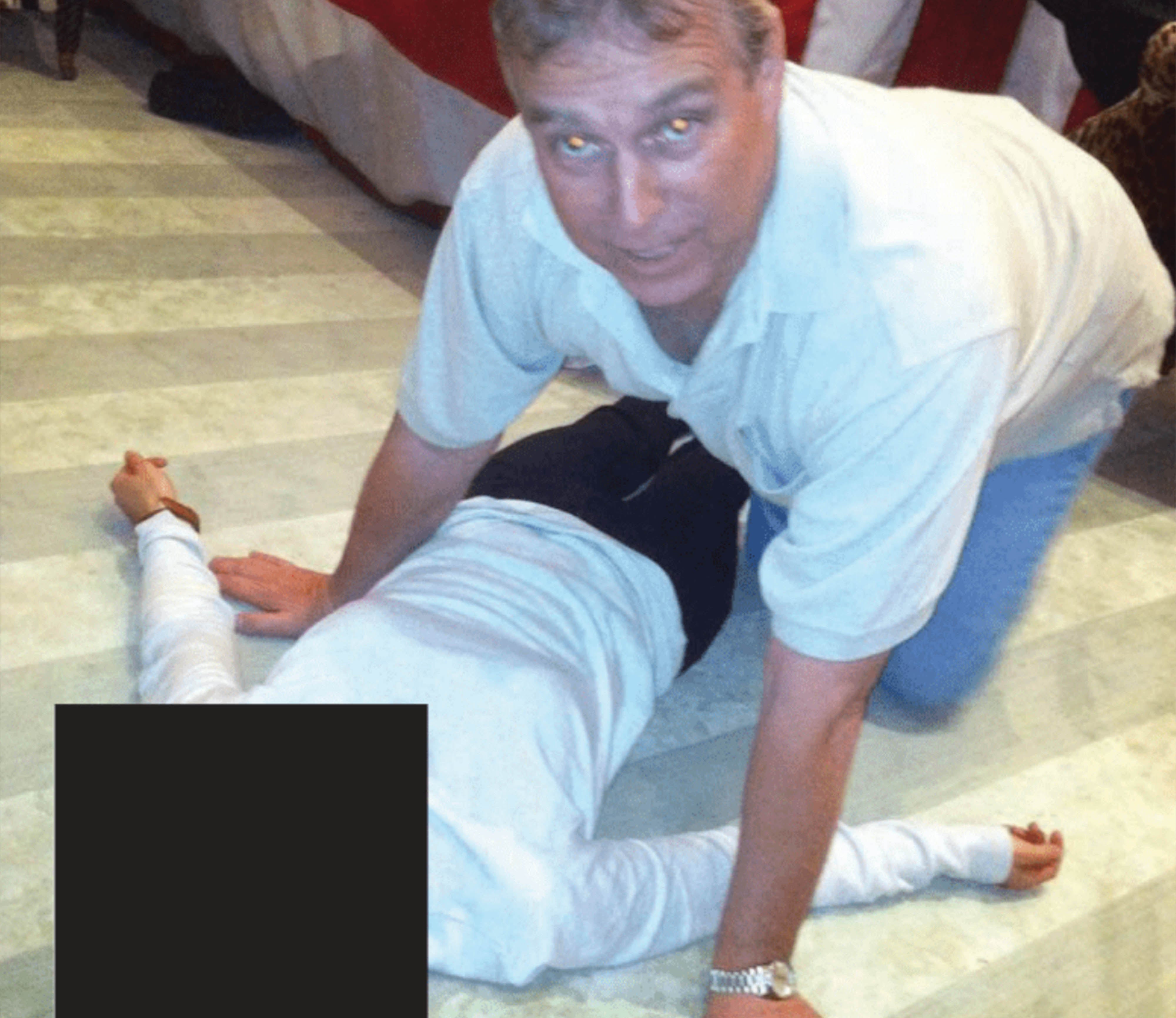 A photo appearing to show Andrew crouched over a woman was included in the latest Epstein files release