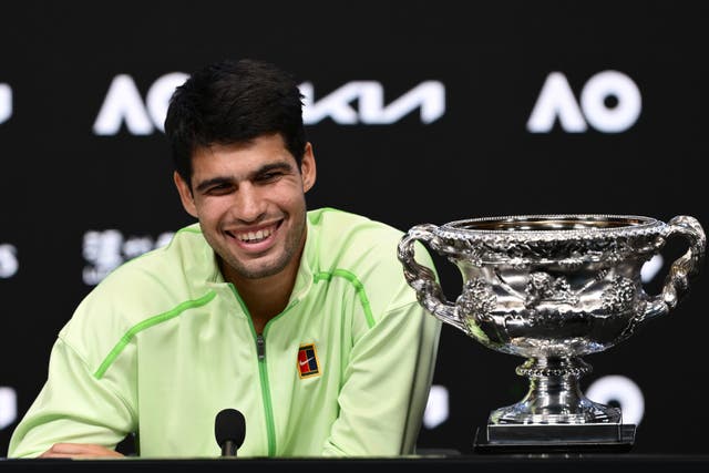 <p>Carlos Alcaraz with his first Australian Open trophy </p>