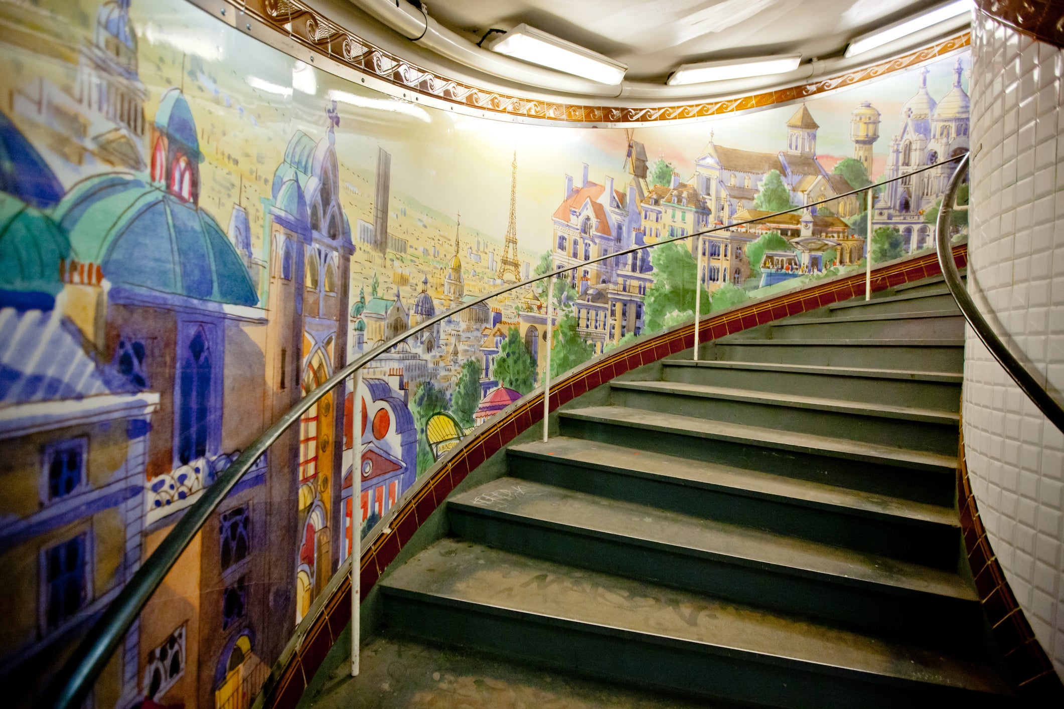 The 176 stairs of Abbesses station are lined with photos and murals like an art exhibition