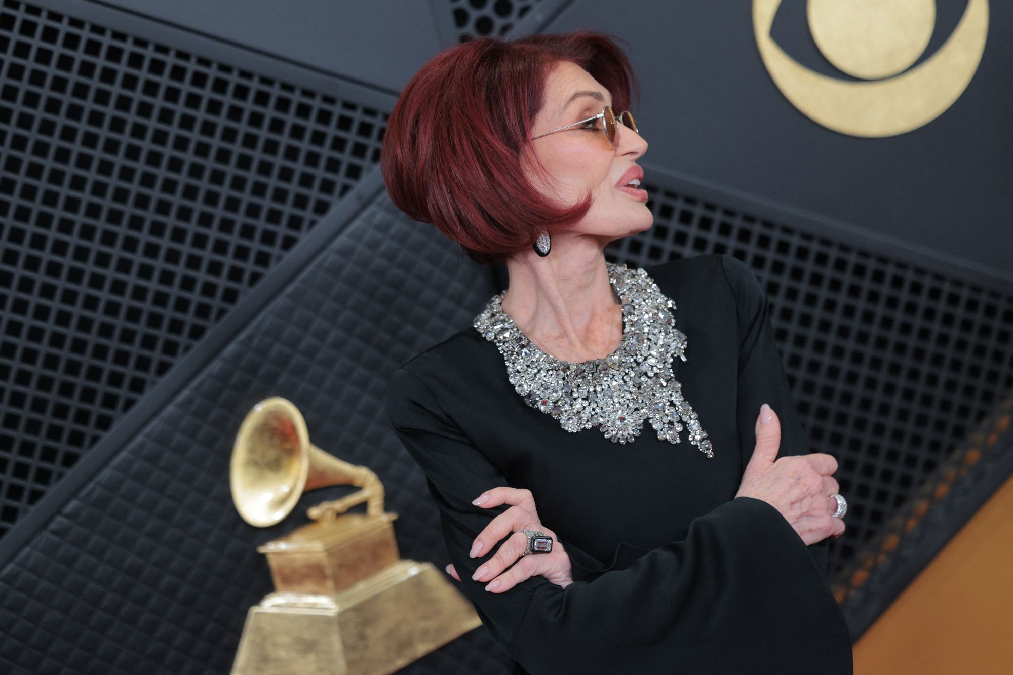 For accessories, Osbourne chose a stunning diamond ring, matching earrings, and yellow sunglasses. She also had her signature, short dark red hair parted to the side