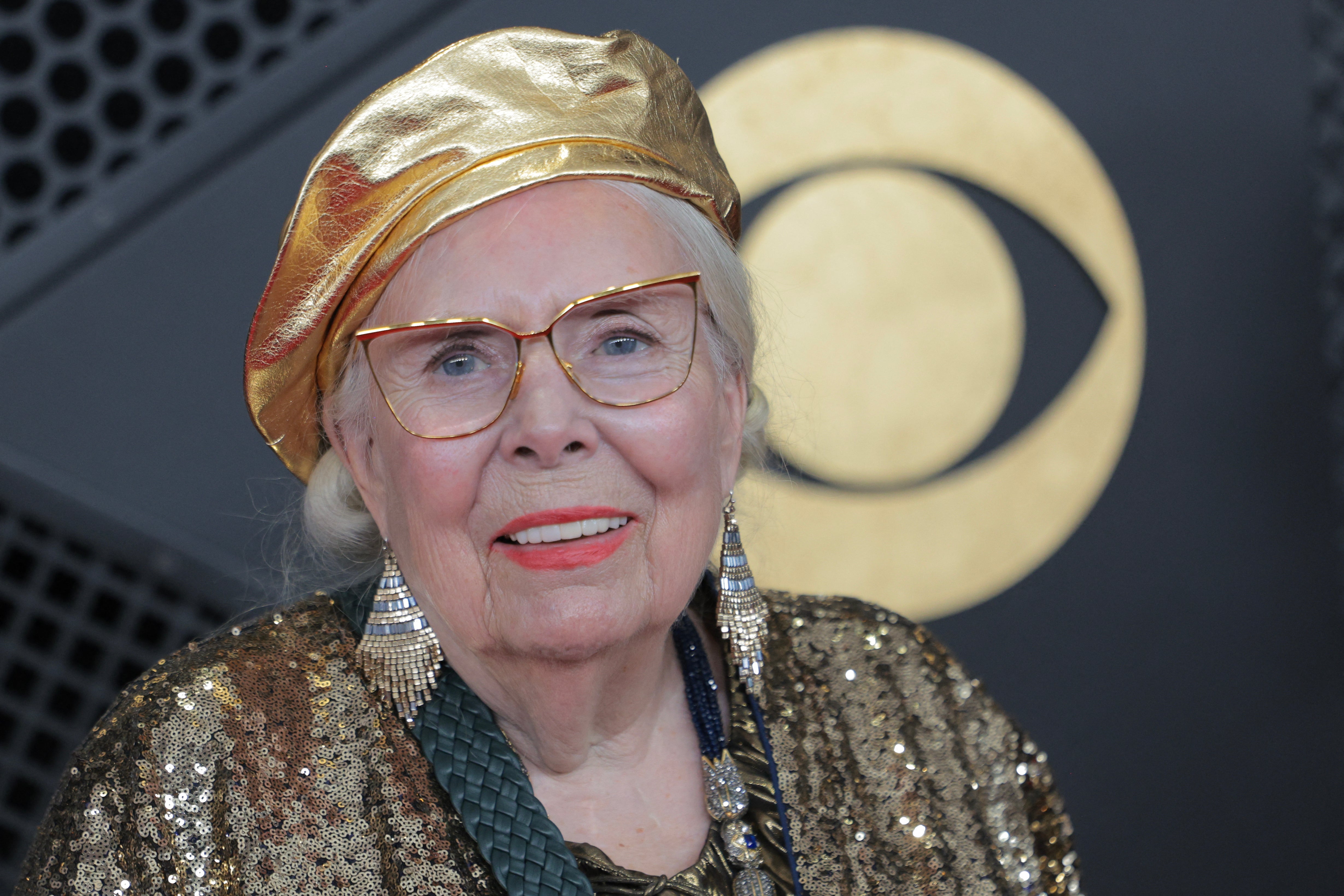Mitchell opted for matching gold accessories, including a stunning beret, long earrings, and yellow-rimmed glasses
