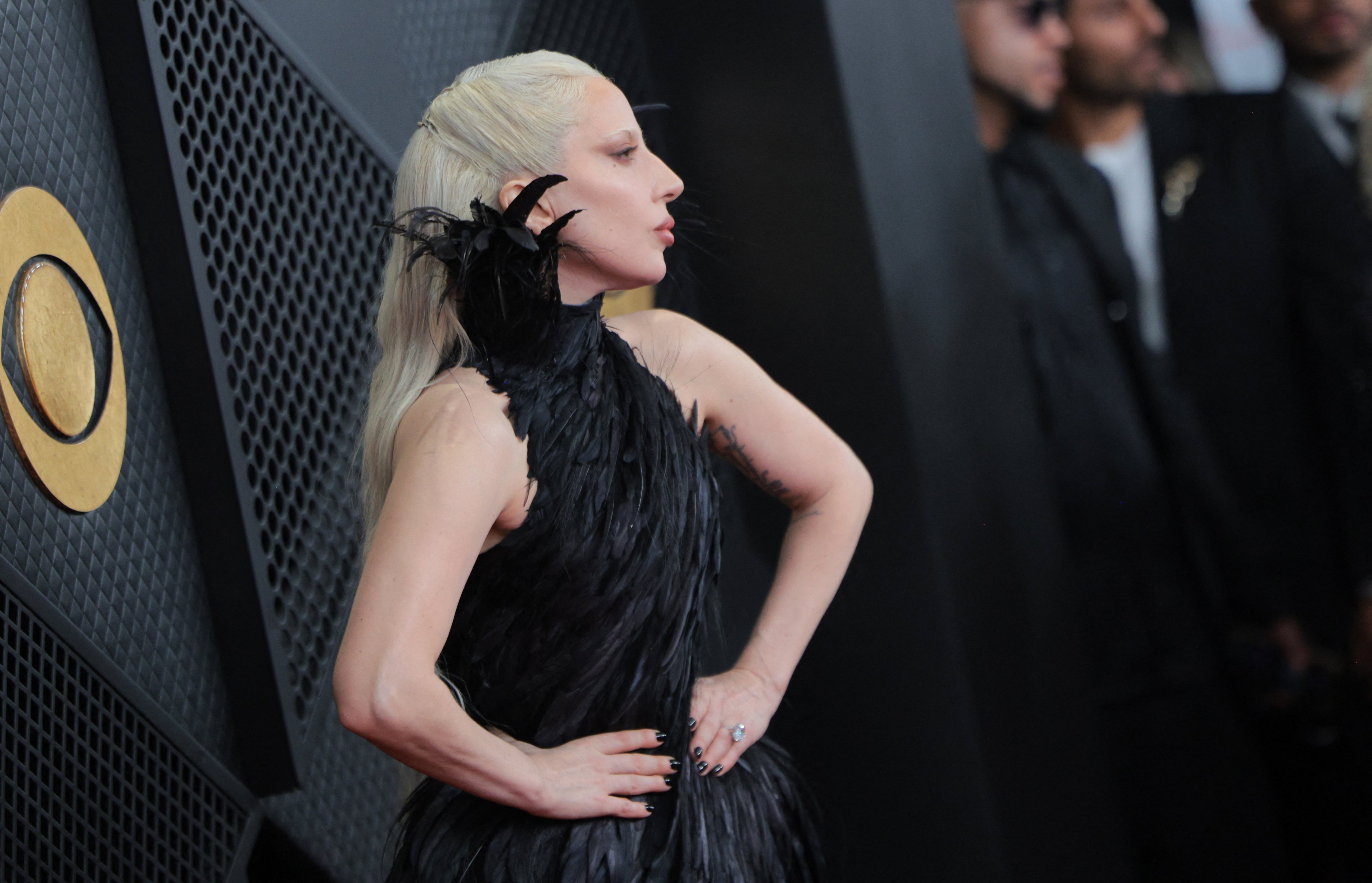 The singer paired her dress, which had an eye-catching feathered neckline, with black nail polish and her massive engagement ring. She wore a subtle pink lipstick and had her hair dyed bleach blonde