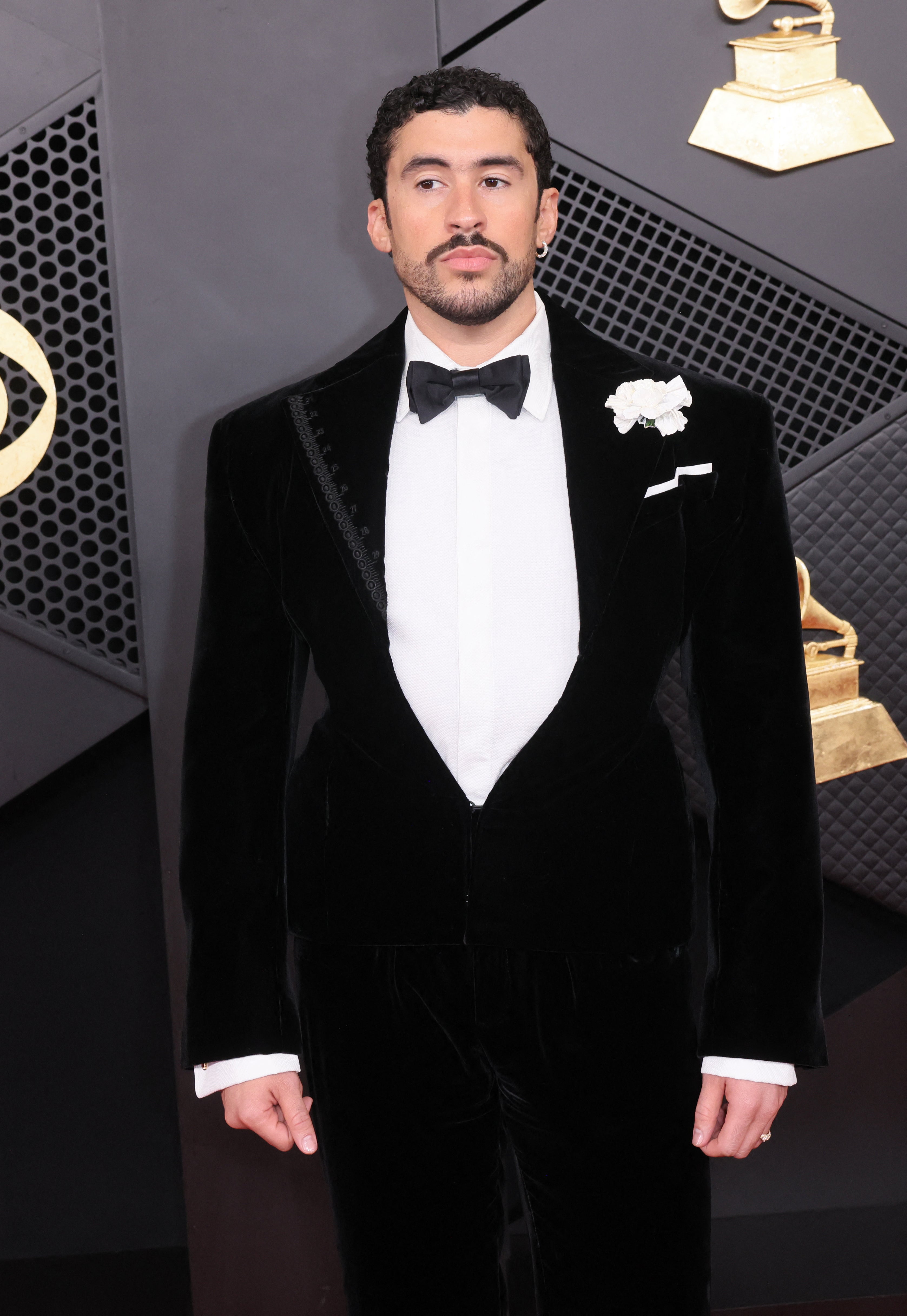 Bad Bunny looked classier than ever in a black velvet tuxedo, with a white boutonniere, and matching bowtie