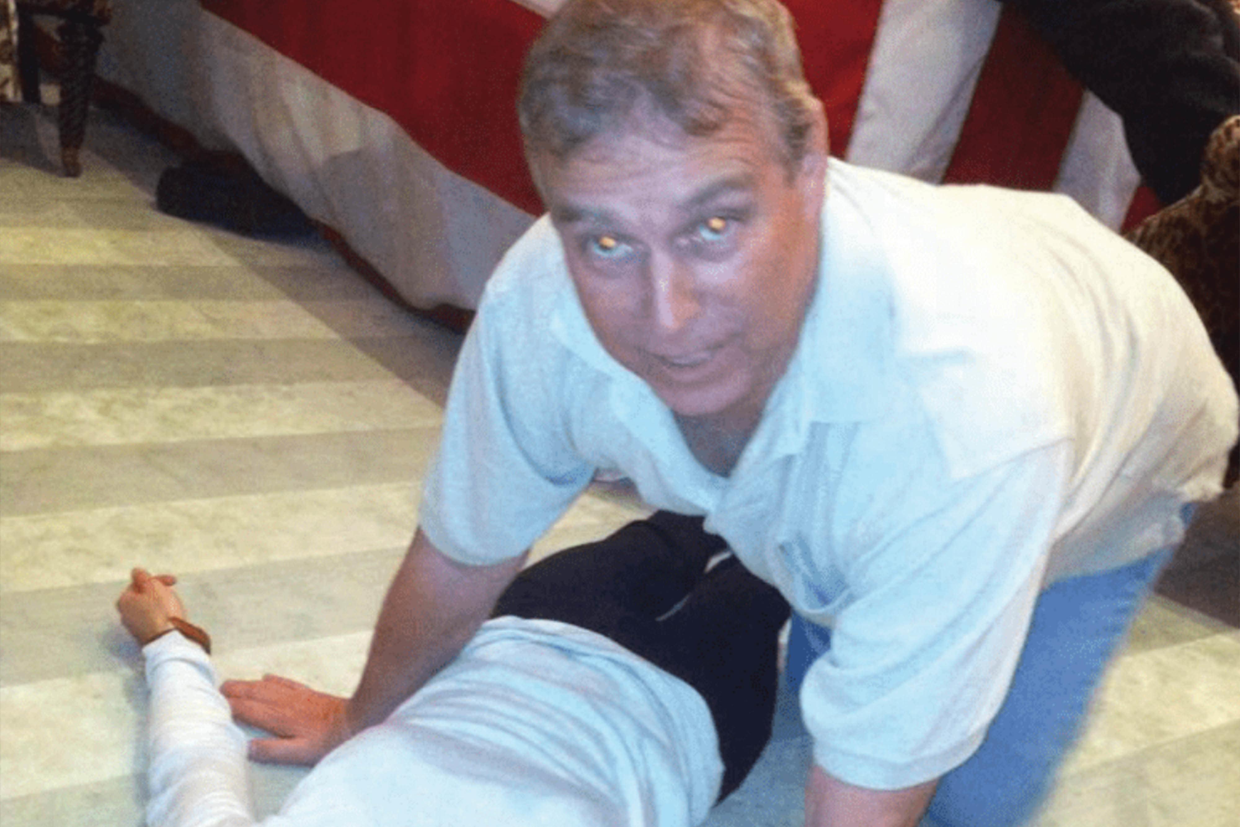 An image issued by the US Department of Justice appearing to show Andrew Mountbatten-Windsor crouched over an unidentified woman