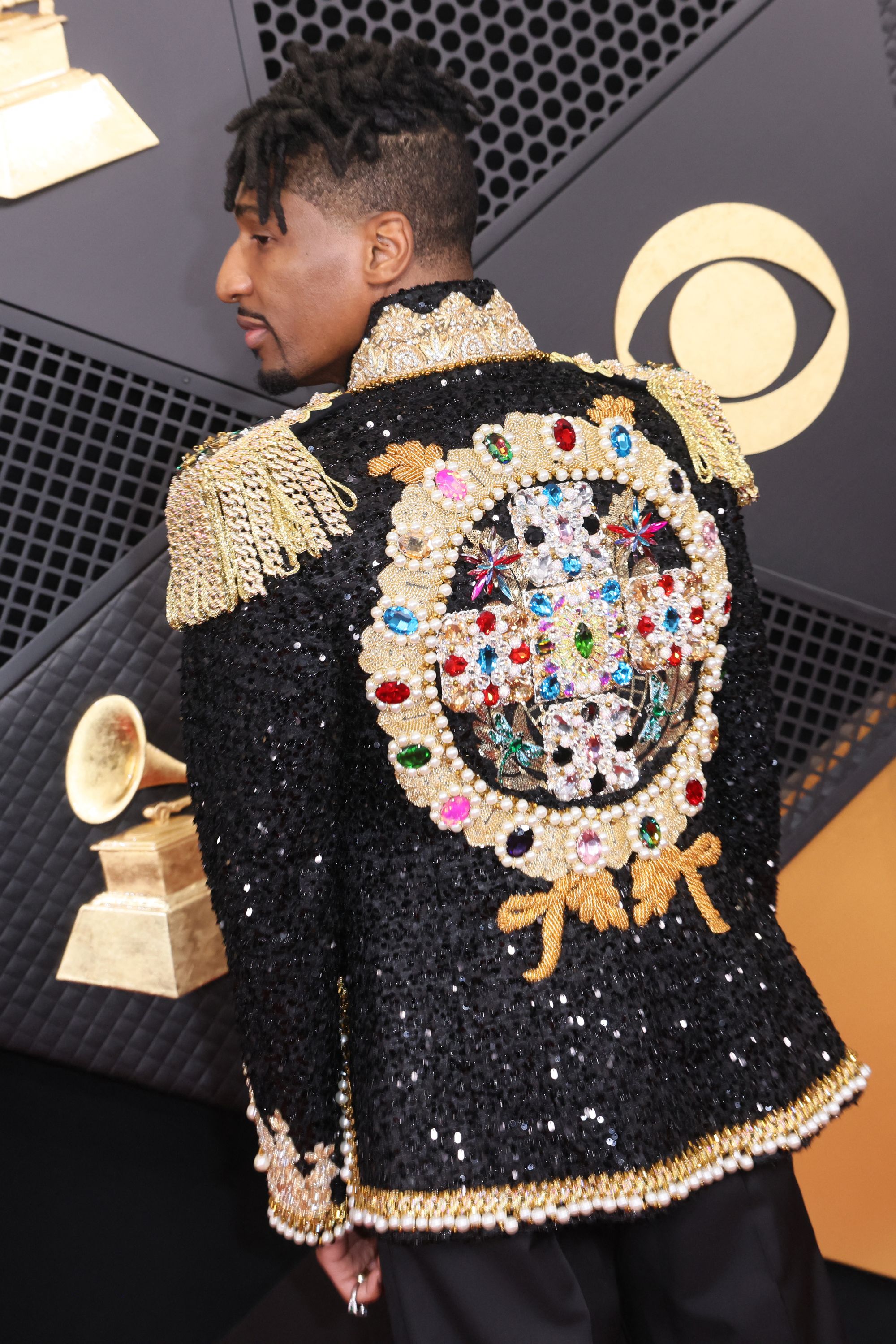 The back of his jacket was nothing short of spectacular, featuring multicolored sequins and gems