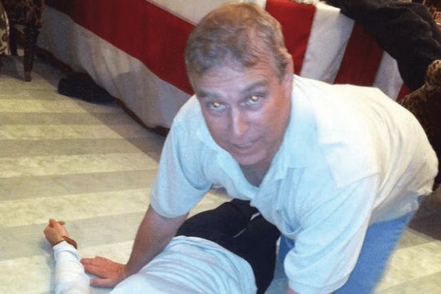 <p>A photograph appearing to show Andrew Mountbatten-Windsor crouched over an unidentified woman which has been released in the latest disclosure of files linked to Jeffrey Epstein</p>