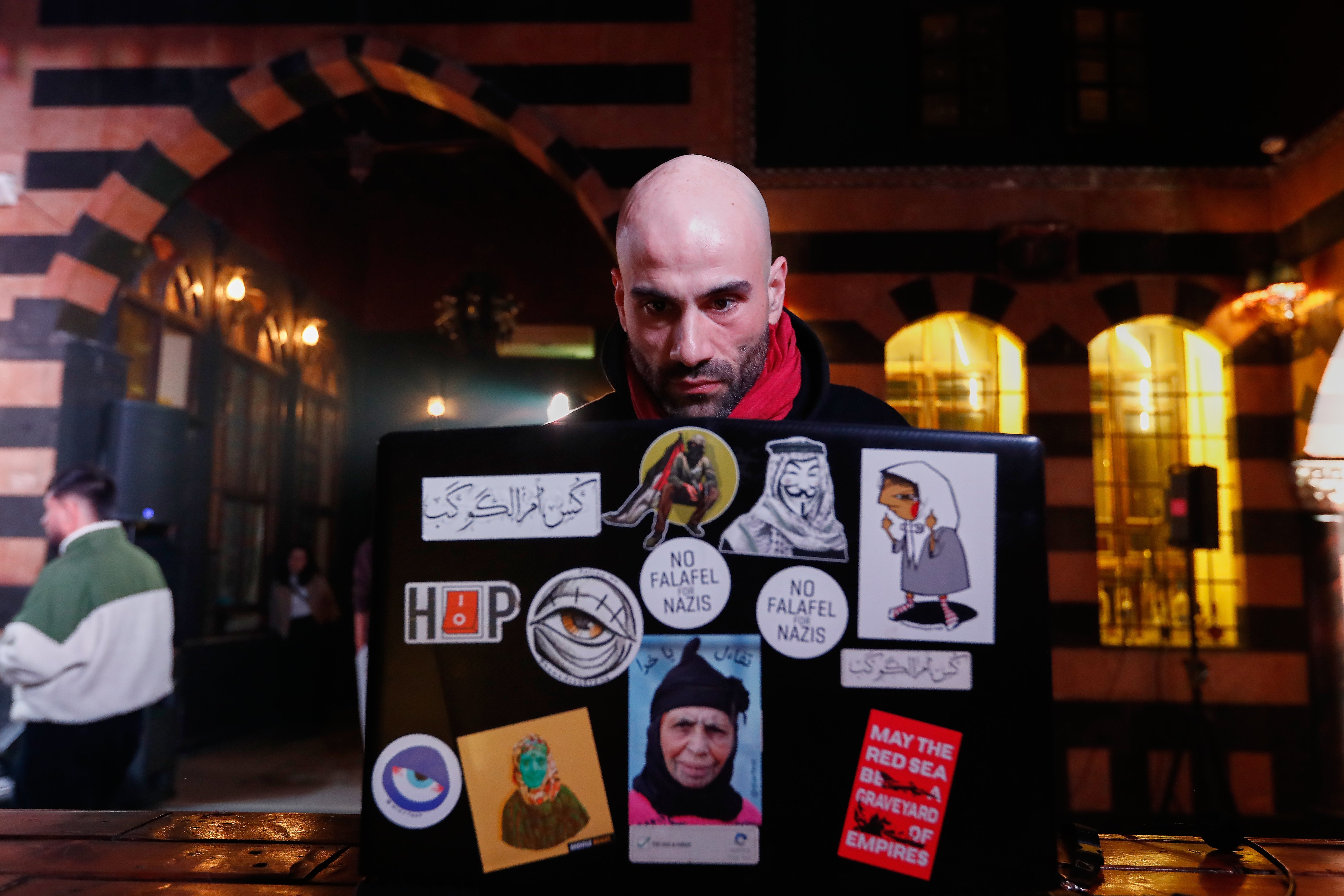 Hani Al Sawah, works on his laptop in old Damascus