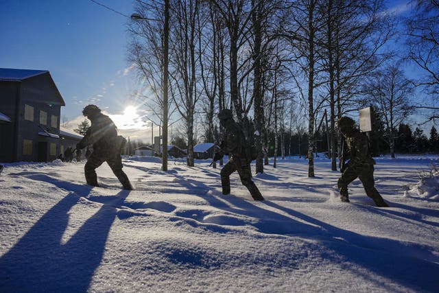 <p>British soldiers patrol through snow (Ben Birchall/PA)</p>
