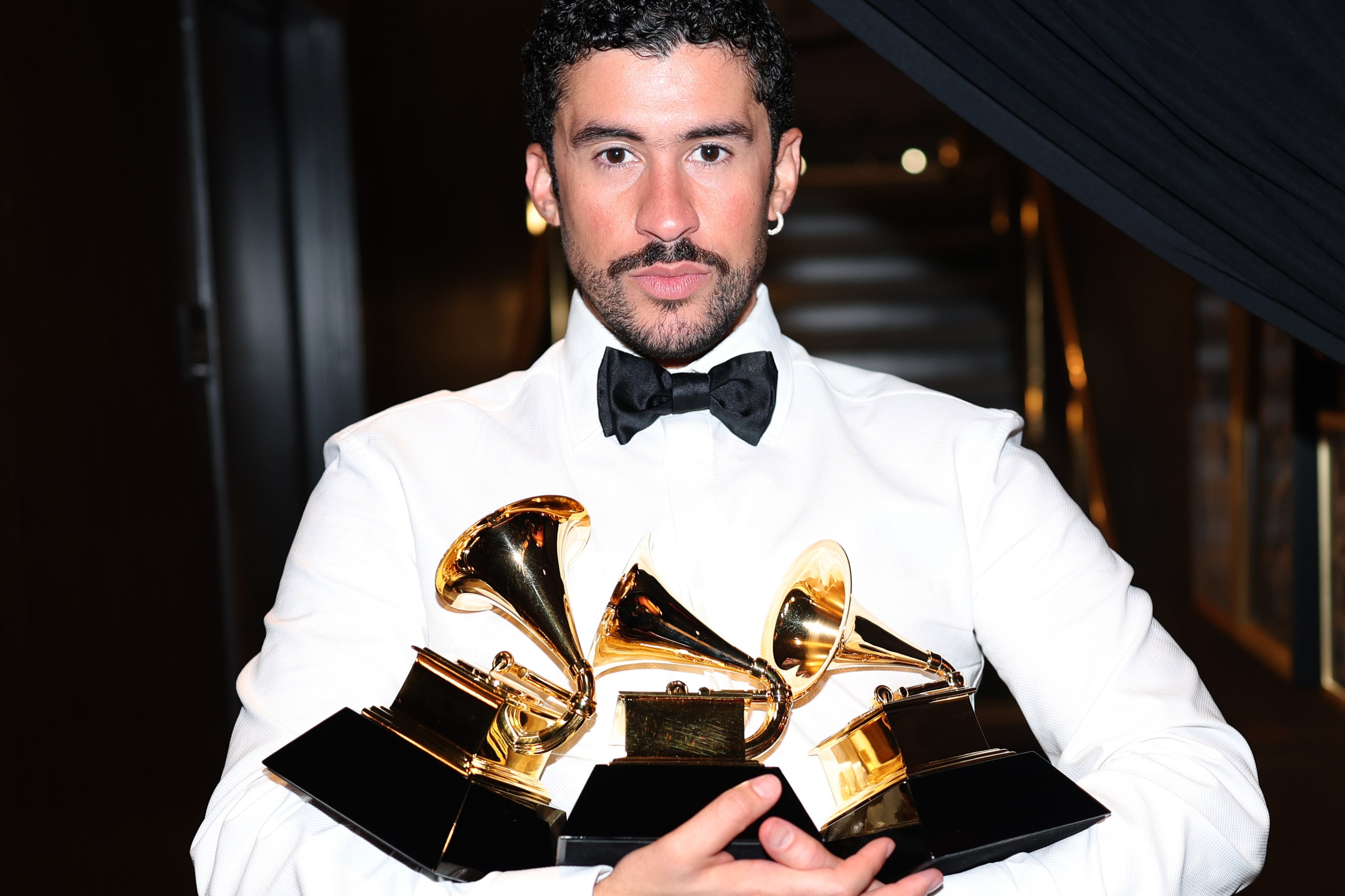 Bad Bunny with his Grammys for Album of the Year, Best Música Urbana Album, and Best Global Music Performance.
