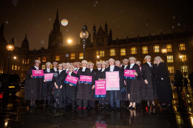 <p>A group of barristers outside the Houses of Parliament ahead of lobby event to discuss why they oppose the government's jury trial proposals</p>