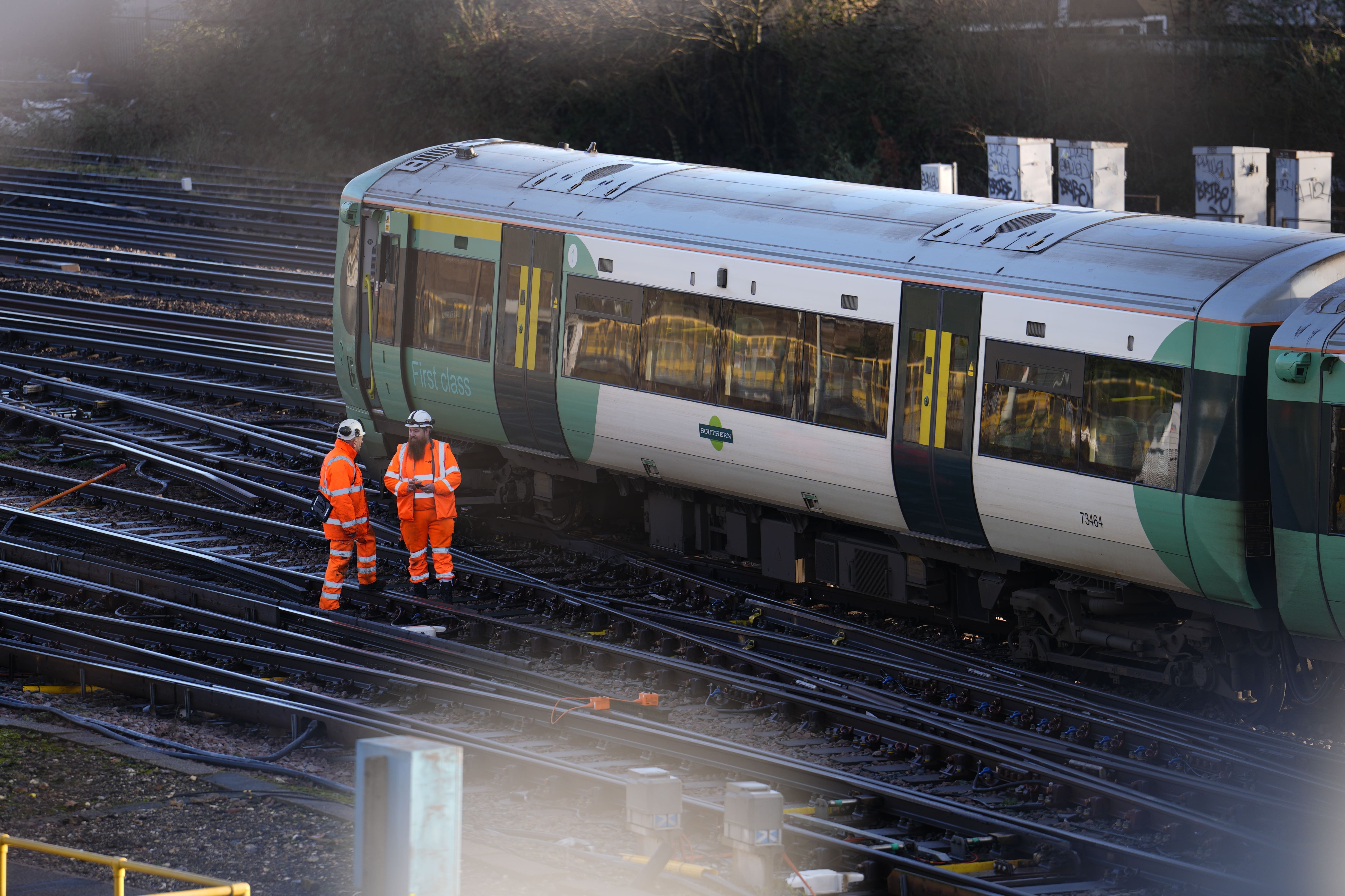 Engineers work on a derailed train at a depot in south-east London (Jordan Pettitt/PA)