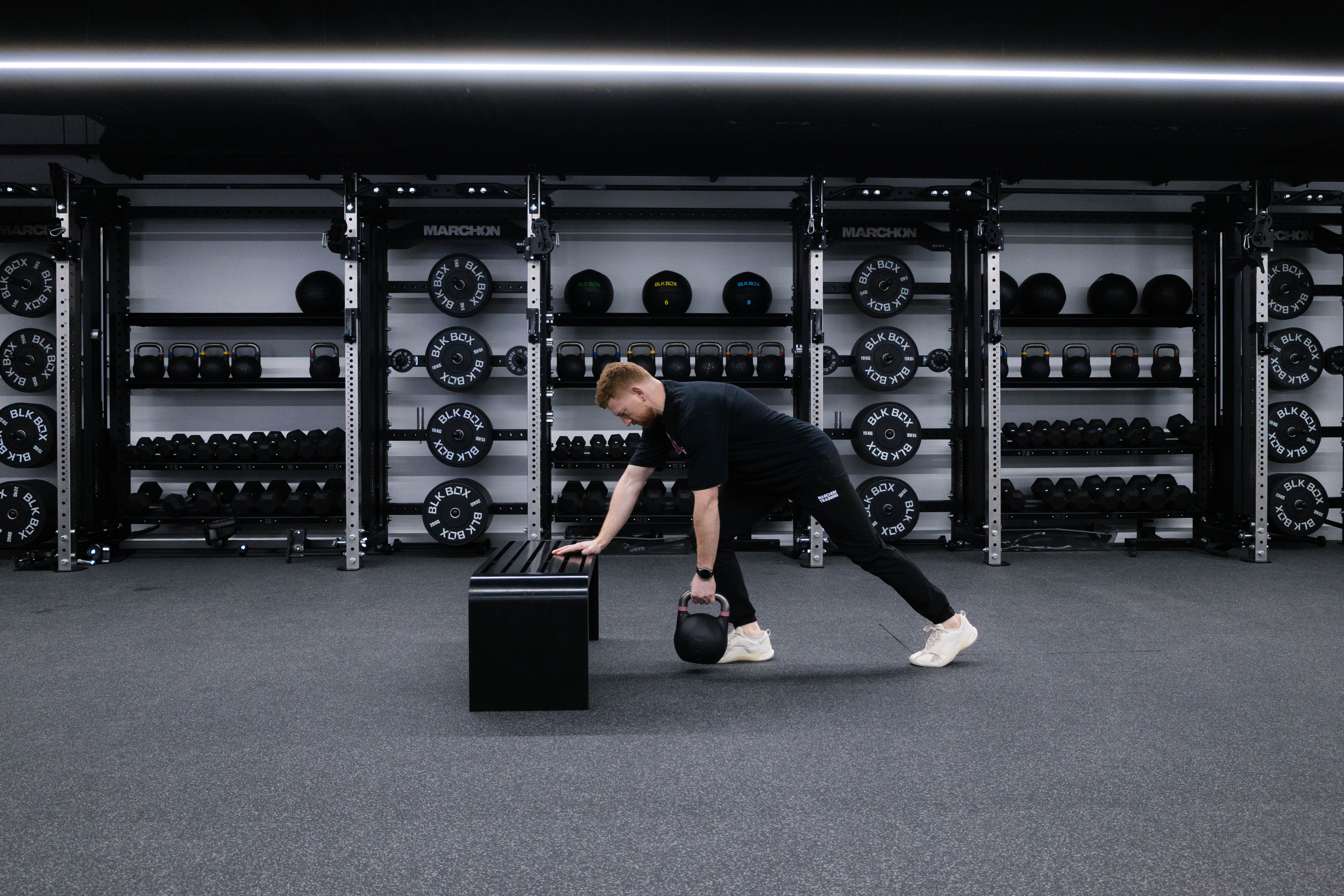 Marchon coach Patrick James demonstrating how to perform a single-arm row with a kettlebell