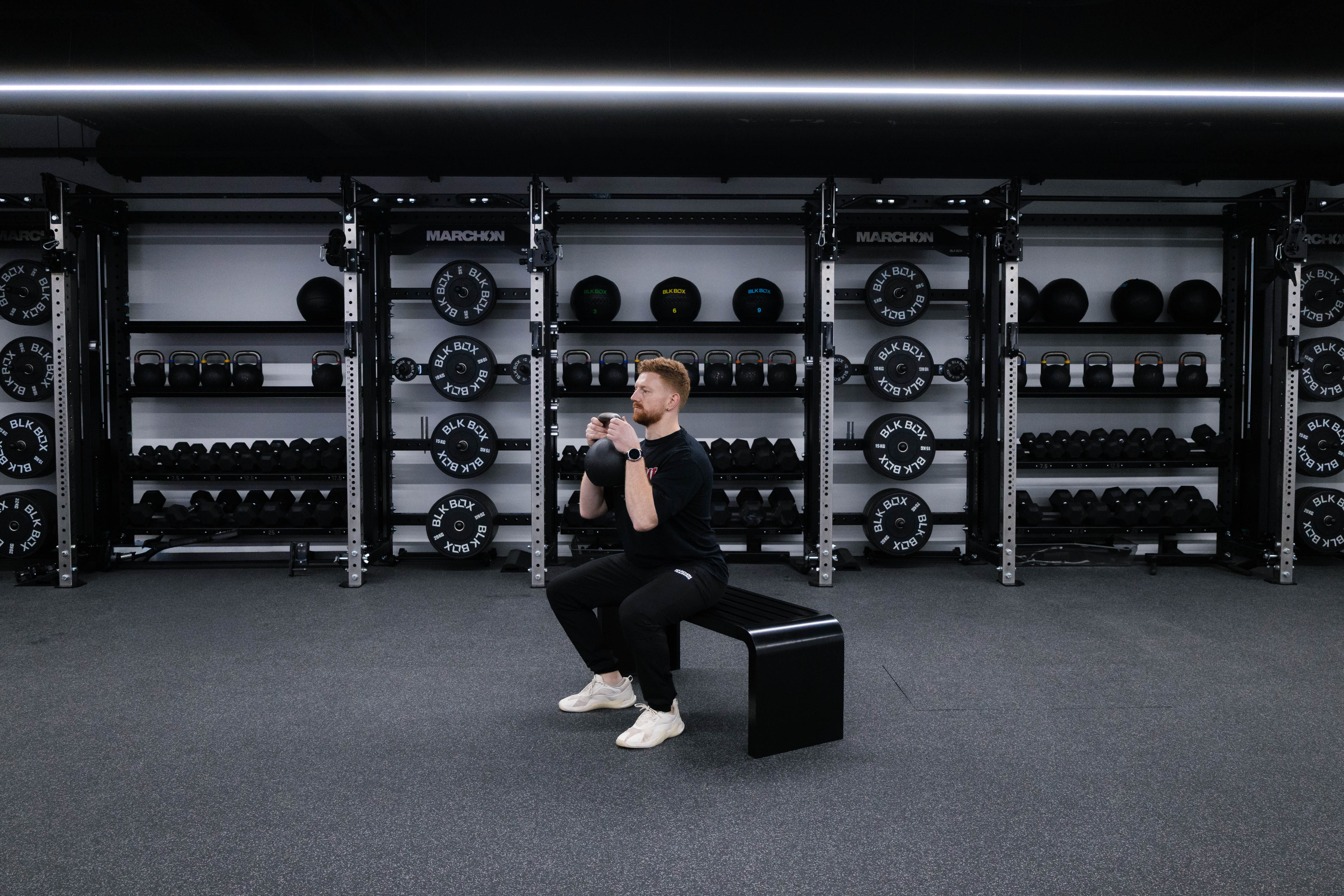 Marchon coach Patrick James demonstrates how to perform a squat to box